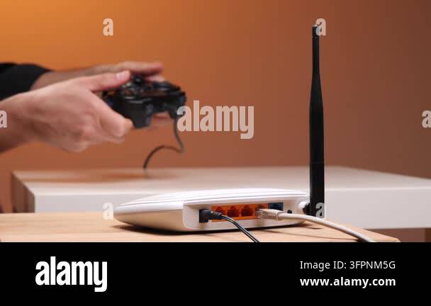 Wireless Ruter Image Persons hands holding a gamepad while playing video games, with a white ...