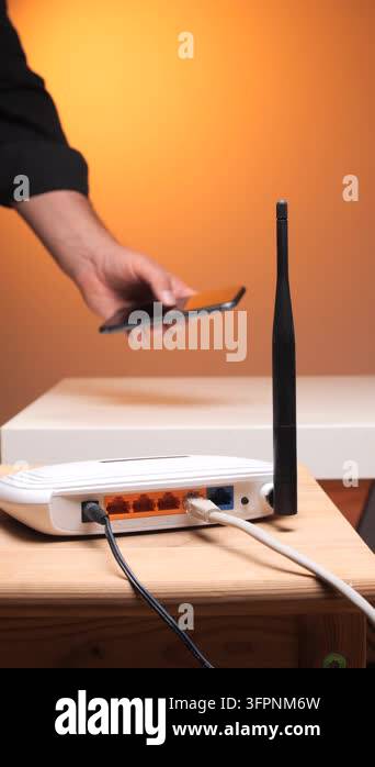 Wireless Ruter Image Vertical video persons hand interacting with a smartphone while a wi fi ...