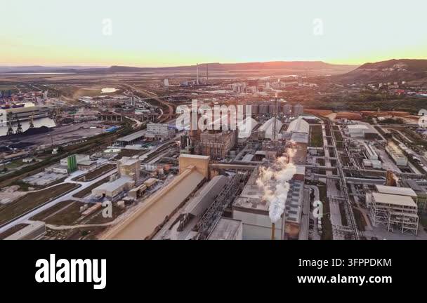 Large Area Smoke rises from several chimneys in a large industrial area. Bright ...