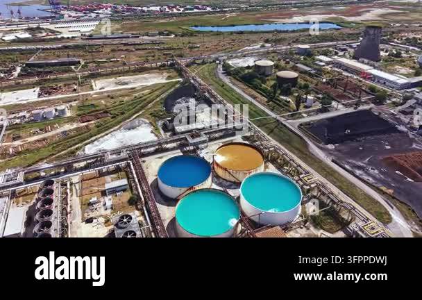 Html Olors Large circular tanks in bright colors are present at an industrial site ...
