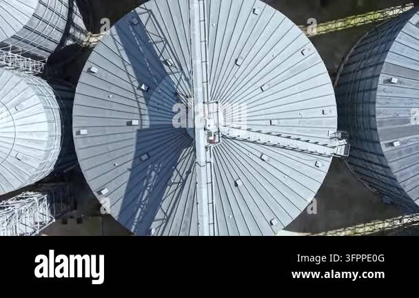 Large Area Large grain silos located in a rural area. The tops of the silos are ...