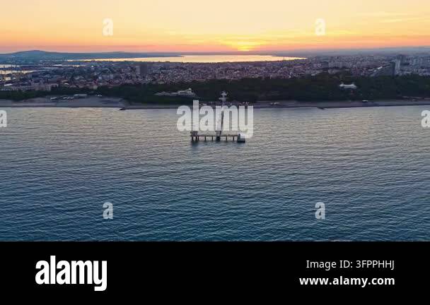 Html Olors The view shows a pier in the water with a city in the background. The ...