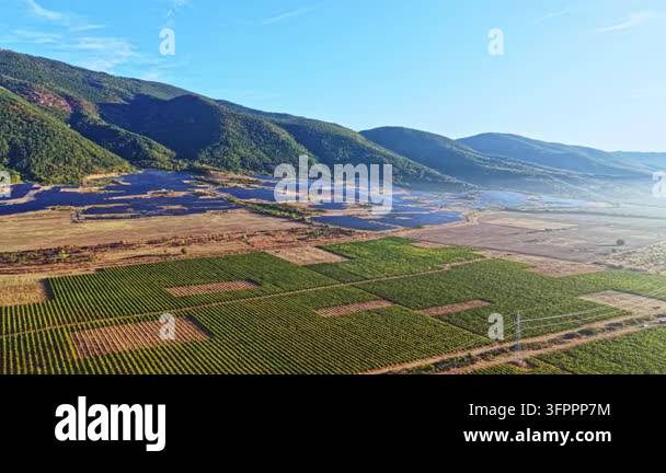 Clea Rsky Background Fields of crops stretch across the land with mountains in the ...