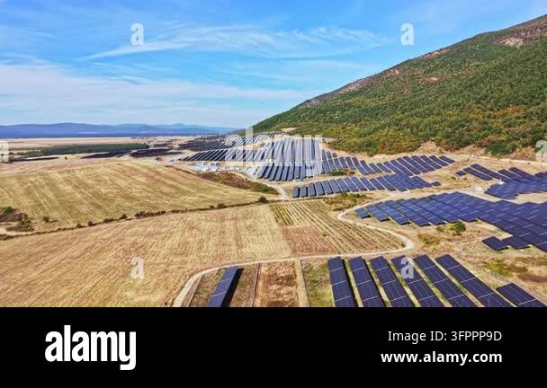 Large Area Large solar panel installation extends across fields and hills. The ...