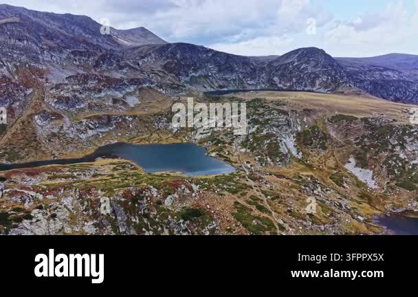 Large Area A large lake is seen in the center of rocky terrain surrounded by hills ...