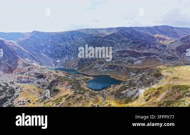 Large Area The scene shows a large mountain area with rocky peaks and two lakes ...