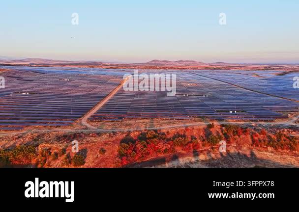 Html Olors Solar panels fill a vast field near hills as sunlight shines on the ...