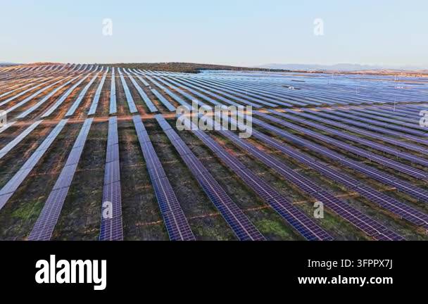 Farm Panel Pattern Large field features rows of solar panels set up in a systematic ...
