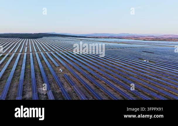 Large Area A large area covered with rows of solar panels stretches across the ...