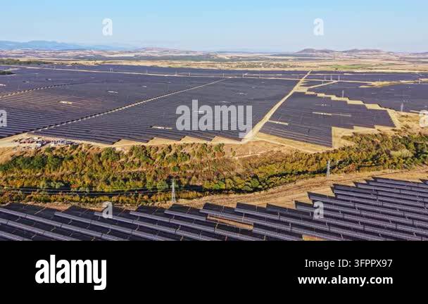Large Area A large solar power facility is visible in a rural area. The rows of ...