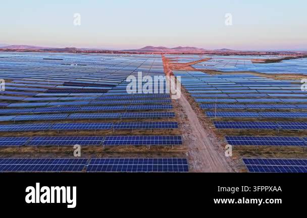 Html Olors Numerous solar panels cover a wide area in a rural location. The panels ...