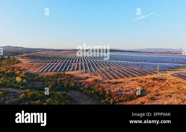 Large Area Rows of solar panels stretch across a wide area in a countryside ...