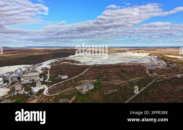 Large Area A mining site is visible in a remote area. Large machinery and ...