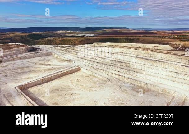 Large Area The scene shows a large quarry filled with earth. The ground is marked ...