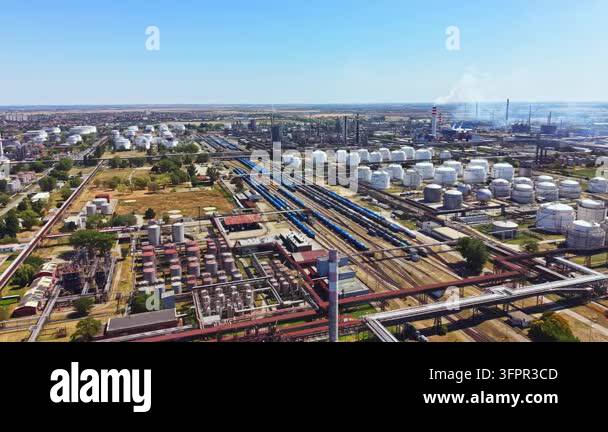 Large Area An aerial view of an industrial area filled with large storage tanks ...