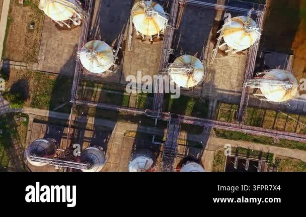 Sign Modle Image Storage tanks and pipelines are arranged on concrete ground in an ...
