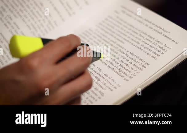 Higlighting Text 4K video of a man's hand highlighting text in a Spanish book with a ...