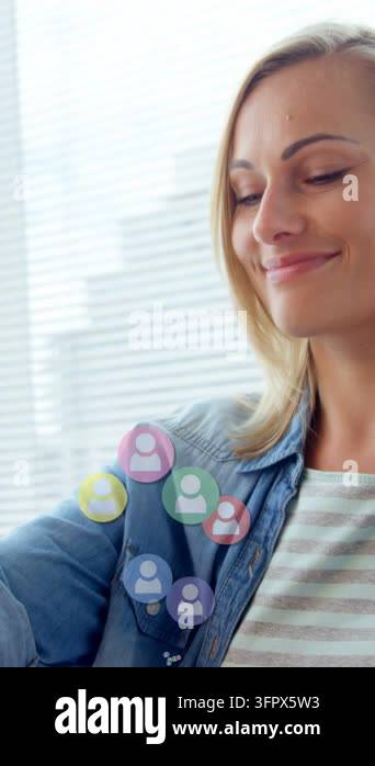 Vertical video: Woman looking at device, tapping and swiping, arranging ...