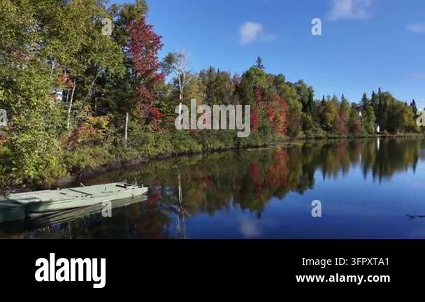 A drone flies near rowboats resting along the shore of Lac du Quinzime ...