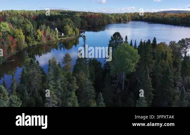 Low-altitude aerial footage reveals a calm recreational lake surrounded ...