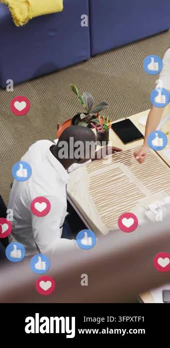 Seated man following woman pointing, examining white box for marketing ...