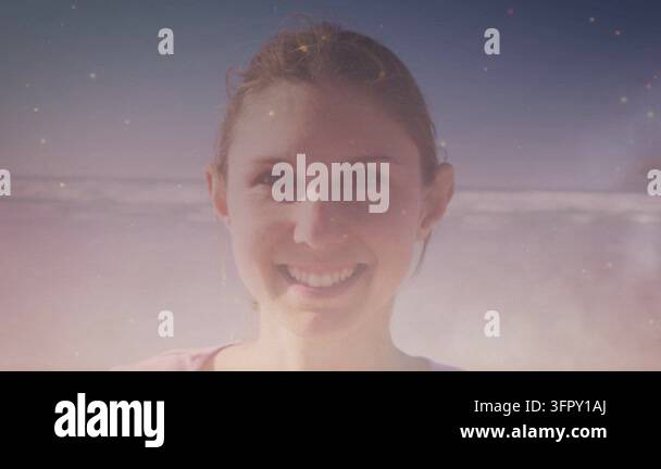 Overlay Html Over Video Woman smiling at camera by sea, sparkle overlay rising over face ...