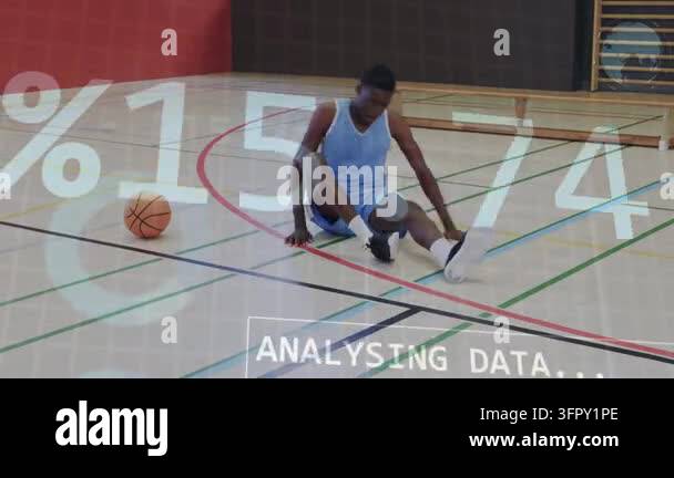 Male athlete doing seated stretches on court after sitting, with data ...
