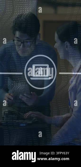 Vertical video: IT duo tapping tablet and typing at bench causing ...
