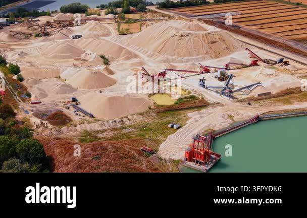 Extensive sand sorting plant with red conveyor belts.. Complex network ...