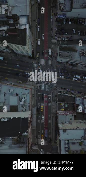 Vertical aerial views in slow motion capture yellow taxi cabs and cars ...