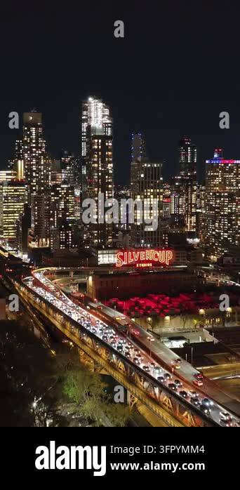 Vertical video: Camera pans across the illuminated Long Island City ...