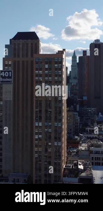 Vertical video: Forwards fly around 401 Broadway high rise office ...