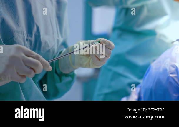 Medical Instrument Signage Unrecognized medic in blue uniform and latex gloves holds a medical ...