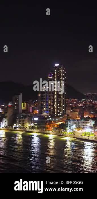 Waterfront High Rises Illuminated high-rise buildings and a busy waterfront reflect across ...