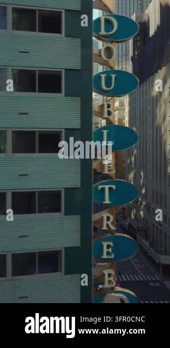 Vertical video: Facade with windows. Sliding reveal of avenue. High ...