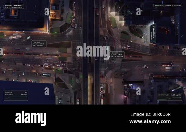 Top down aerial view of Warsaw at night: wide intersection, tram tracks ...