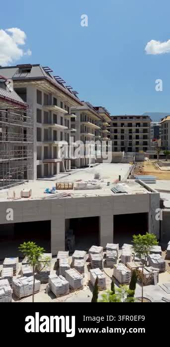 Construction site with unfinished apartment buildings, scaffolding ...