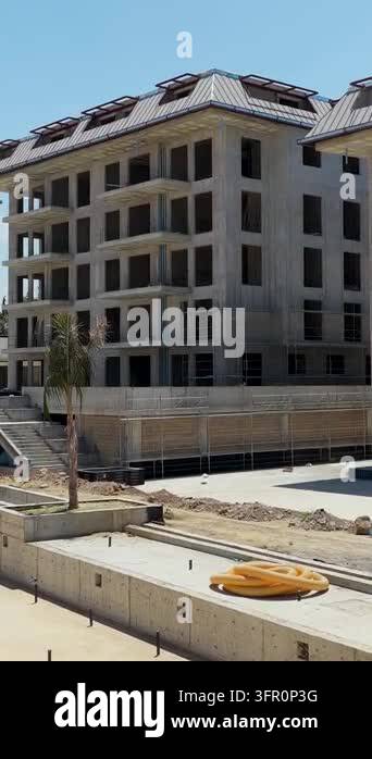 Concrete apartment building under construction with scaffolding, open ...