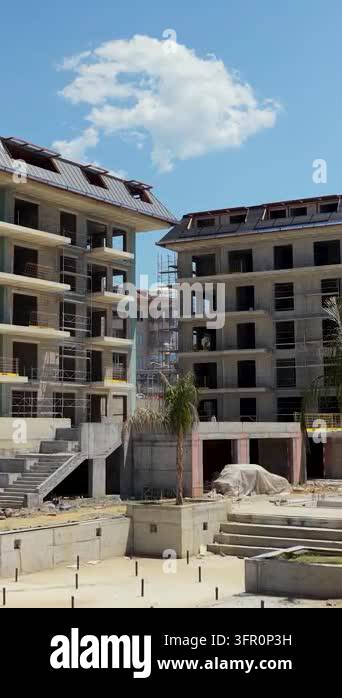 Multi-story residential buildings with scaffolding, unfinished ...