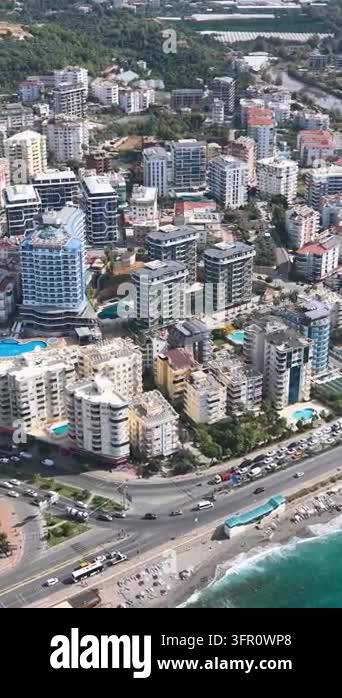 High-rise residential buildings, swimming pools, roads, and a beach are ...