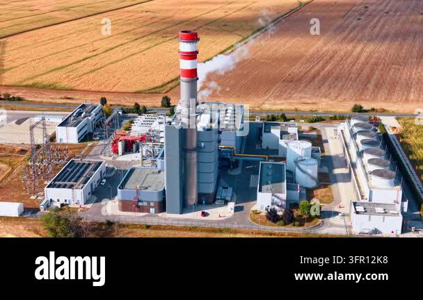 Power station chimney with vapor above cooling equipment. A white plume ...