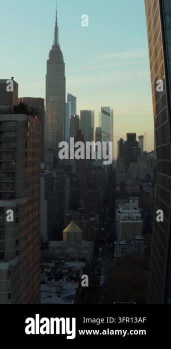 Vertical video: Forwards fly between high rise apartment buildings ...