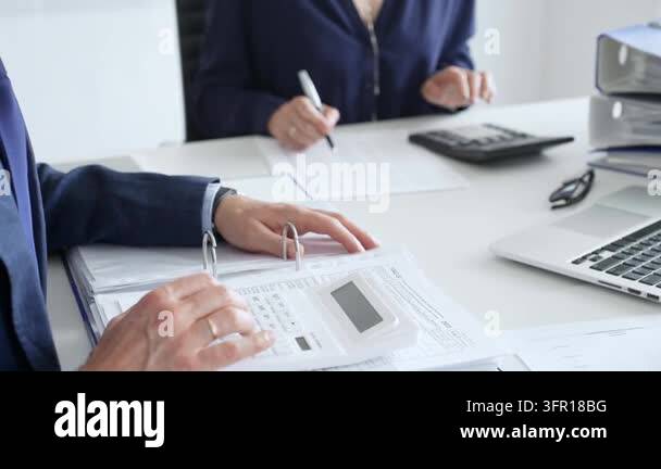 Professional accountants working together at sleek workspace, reviewing ...
