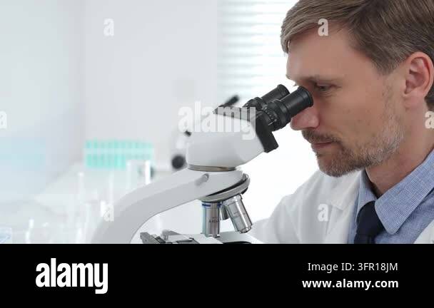 Medical Instrument Signage Scientist peering into microscope, analyzing medical research with ...