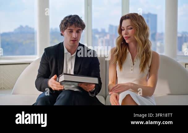 Couple reading interior design book luxury apartment sofa. Elegant man ...