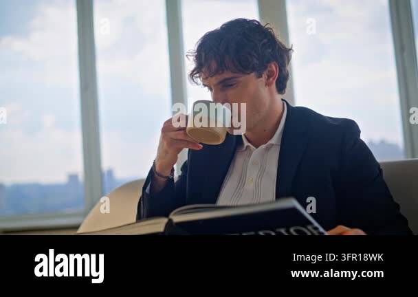 Businessman drinking coffee reading interior design book luxury ...