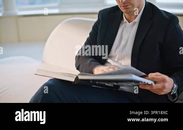 Magazine Photo Frame Man reading interior design book sitting sofa luxury apartment. Focused ...