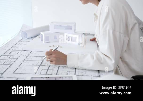 Architect hands using a compass and ruler on a detailed blueprint ...