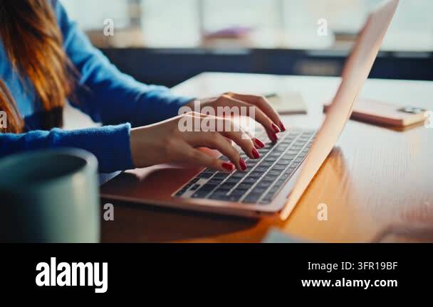 Female hands typing laptop keyboard close up, red manicure fingers ...