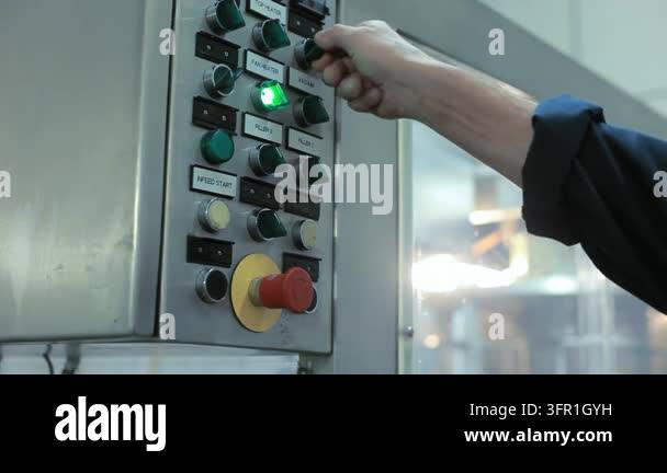 Design Button Food Factory operator pressing green start button industrial control panel ...